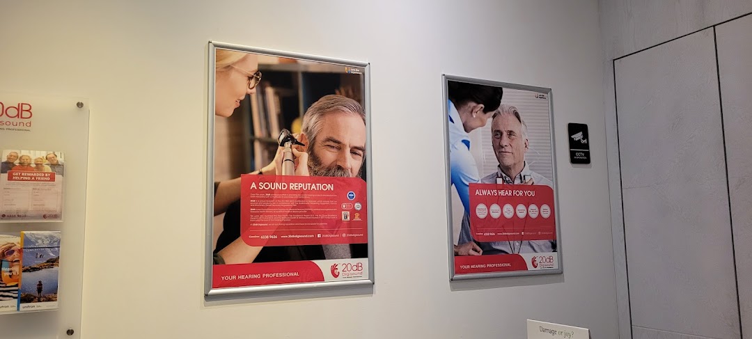 Interior view of 20dB Digisound featuring promotional posters and brochures about hearing solutions.