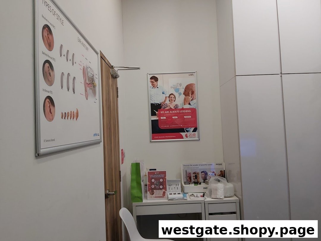 An interior view of a hearing aid clinic, featuring informational posters on ear anatomy and hearing aid styles.