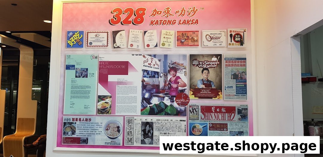 A wall display showcasing numerous awards, media features, and newspaper clippings for 328 Katong Laksa.