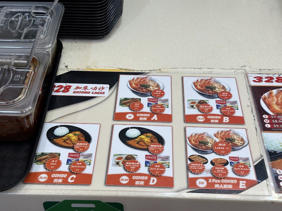 A vibrant menu display showcasing various Laksa and Chicken Curry Rice combos with drinks and sides.