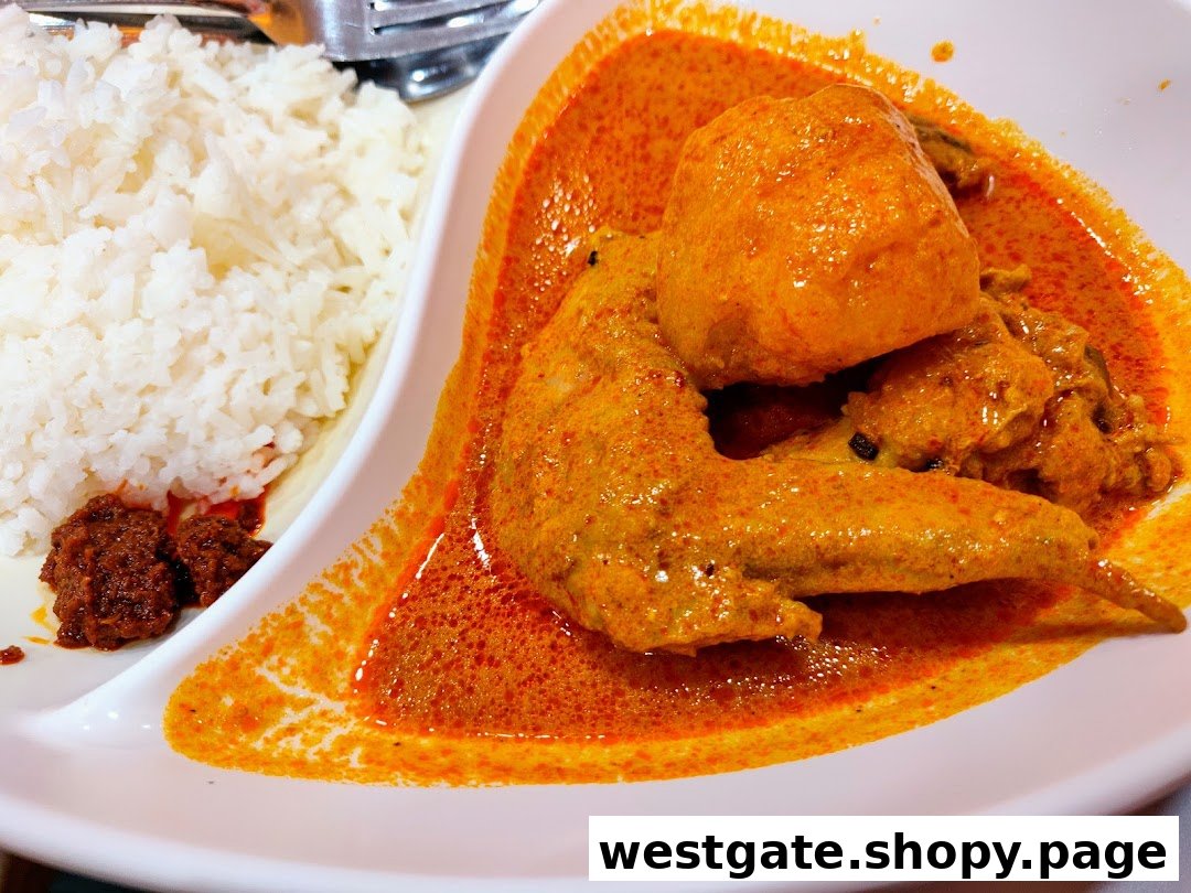 A vibrant plate of chicken curry with rice and sambal, showcasing a delicious meal.