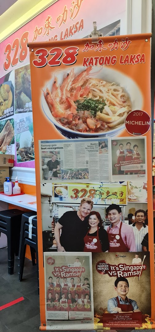 A promotional banner for 328 Katong Laksa, highlighting its Michelin recognition and celebrity encounters.