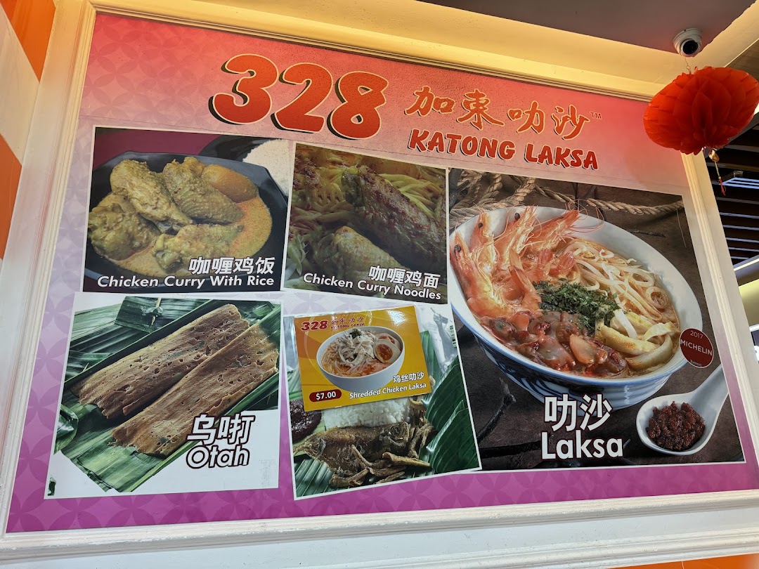 A vibrant display board showcasing popular dishes and prices from 328 Katong Laksa, including their famous Laksa.