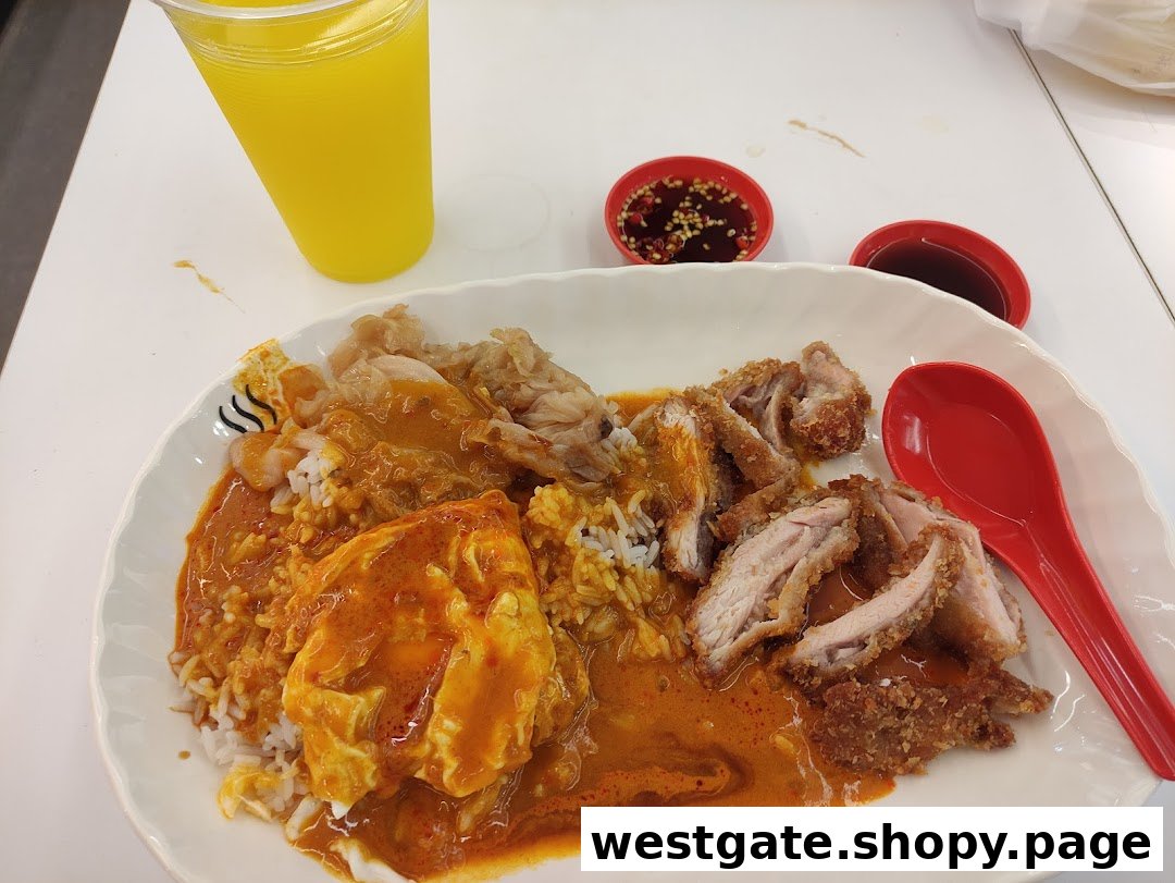 A plate of rice with fried chicken, braised meat, and curry egg, served with sauces and a drink.