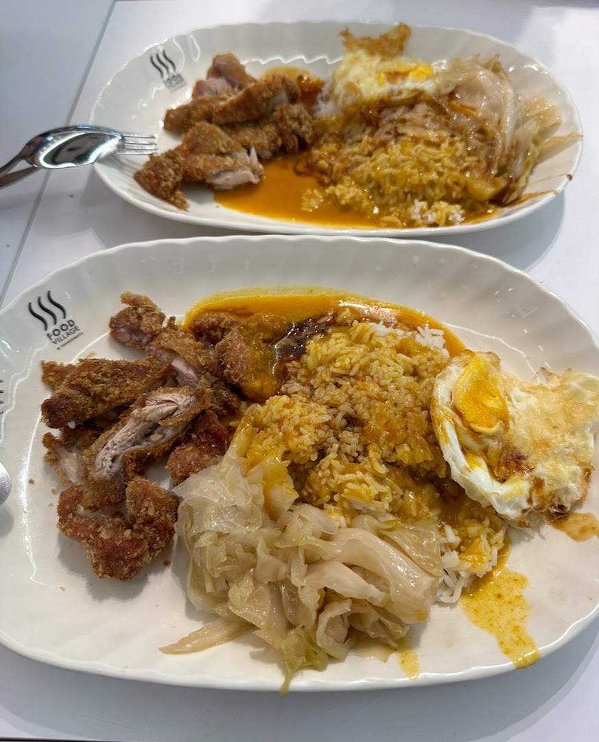 Two plates of crispy fried chicken cutlet with rice, gravy, braised cabbage, and a fried egg.