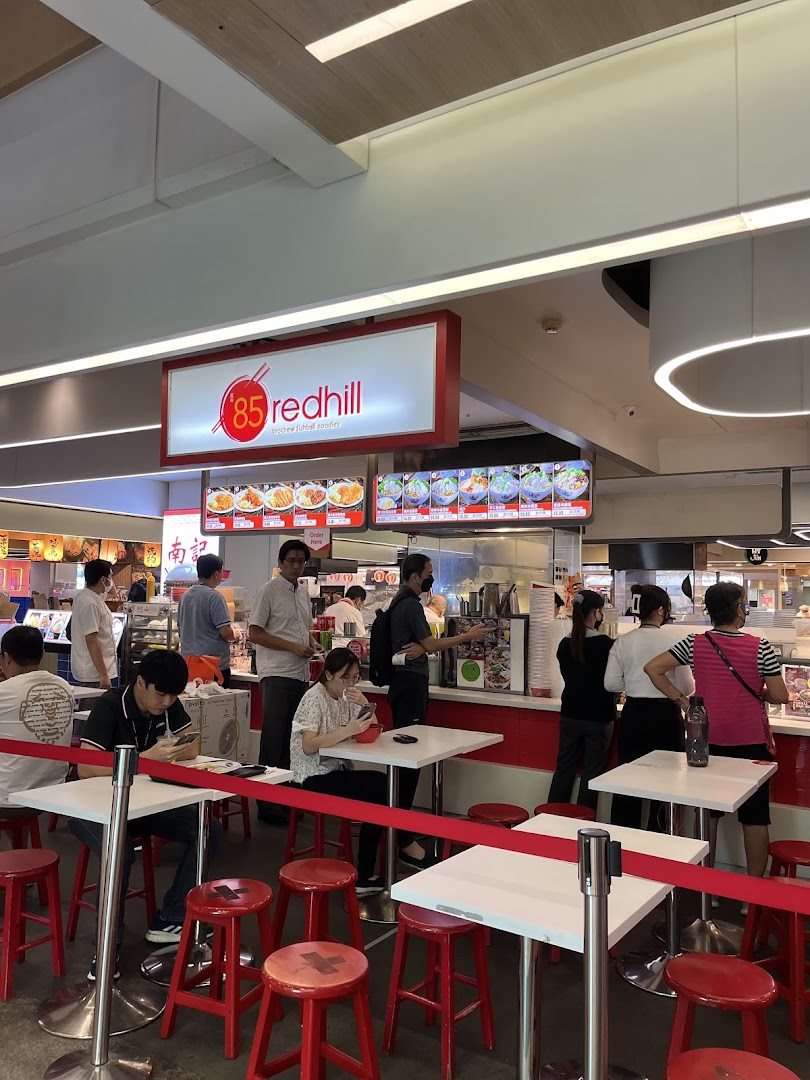 A bustling scene at 85 Redhill Teochew Fishball Noodles, with customers ordering and dining.