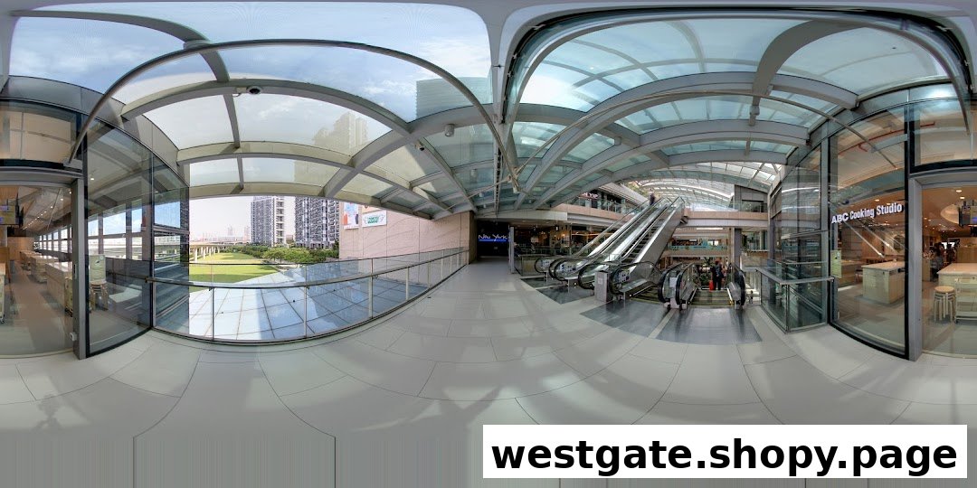Panoramic view of a modern shopping mall interior with escalators and ABC Cooking Studio entrance.