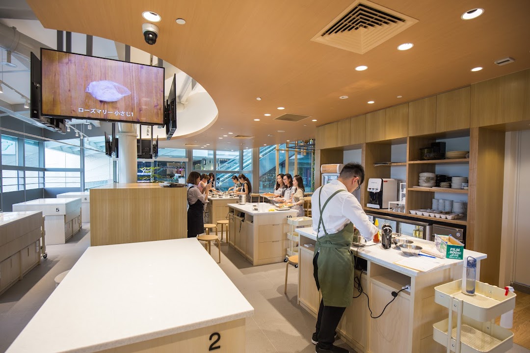 An interior shot of ABC Cooking Studio showing students and an instructor during a hands-on cooking class.