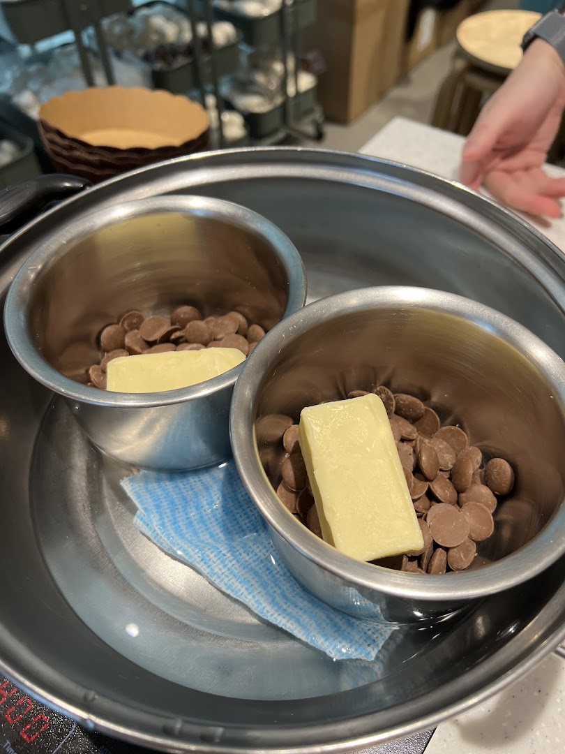 Chocolate chips and butter in bowls, ready for melting in a double boiler setup.