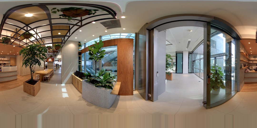 A panoramic view of ABC Cooking Studio's modern and spacious interior with cooking stations and reception.