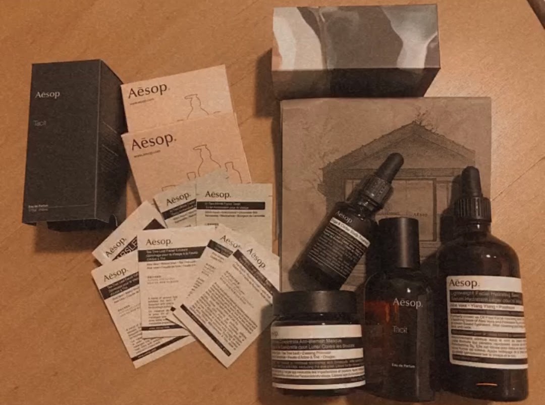 Various Aesop skincare products, including bottles, jars, and samples, are displayed.