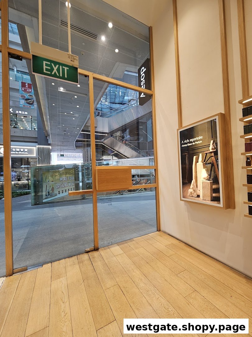 Aesop store entrance with glass doors opening to a bright shopping mall interior.
