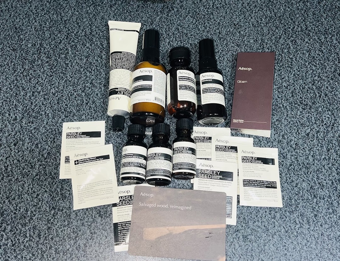 A collection of Aesop skincare and fragrance products, including Parsley Seed range and Gloam perfume.