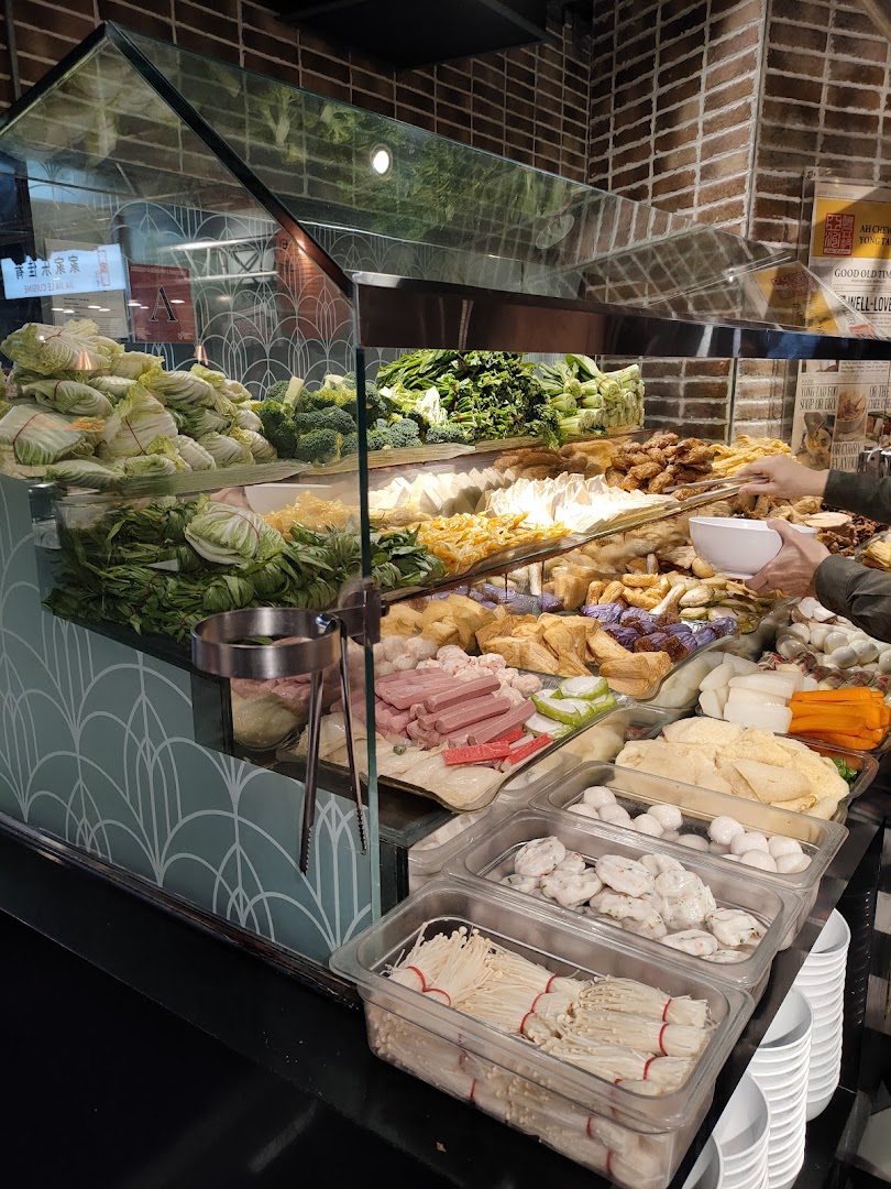 A vibrant display of fresh vegetables, tofu, and various ingredients for Yong Tau Foo at a food stall.