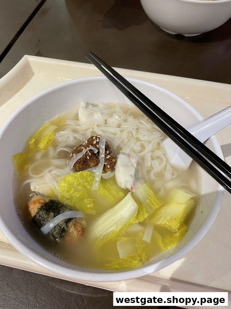 A close-up of a delicious bowl of Yong Tau Foo with noodles, vegetables, and various ingredients.