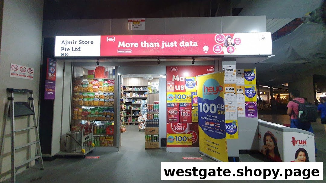 The shop front of Ajmir Store, a convenience store offering snacks, drinks, and mobile data plans.