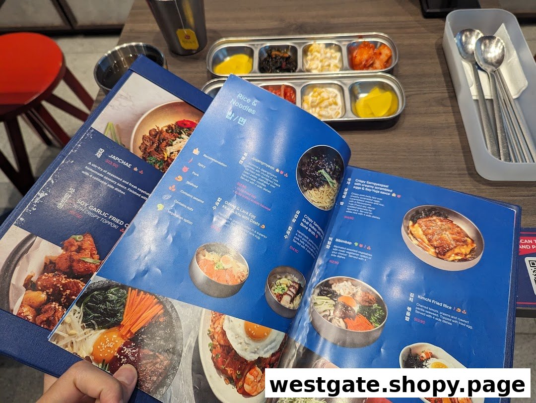 A close-up view of an open Korean restaurant menu displaying various dishes and prices.