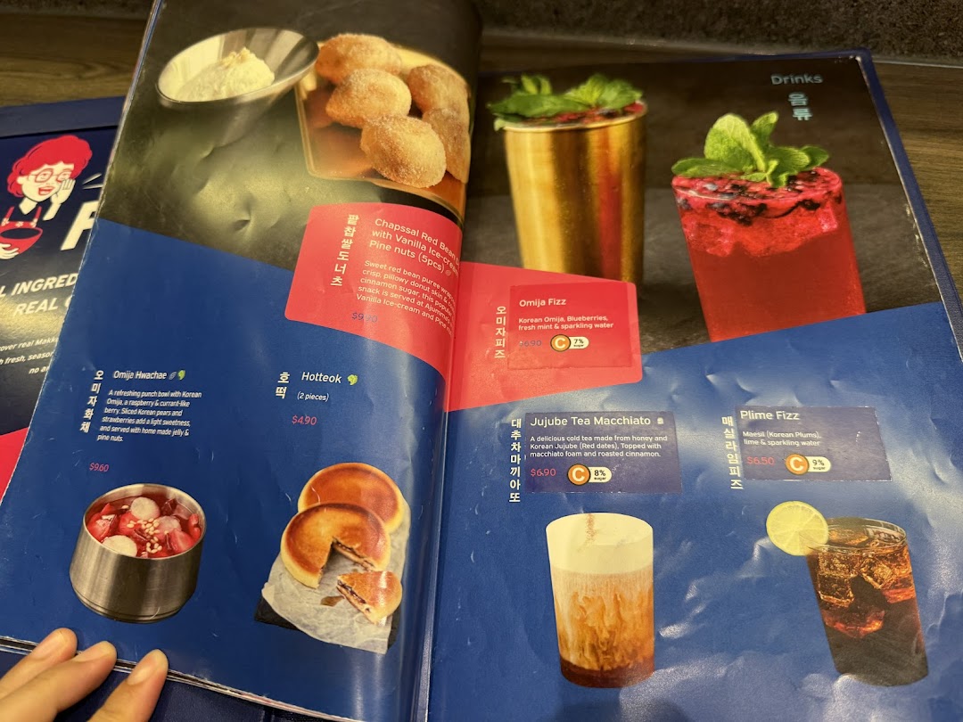 A vibrant menu displaying Korean desserts, snacks, and refreshing beverages with prices and descriptions.