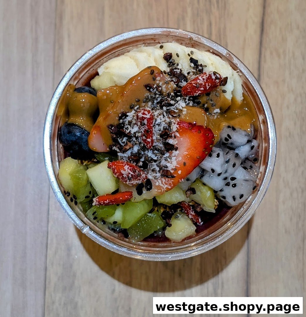 A vibrant açaí bowl topped with fresh fruits, nuts, and drizzles.