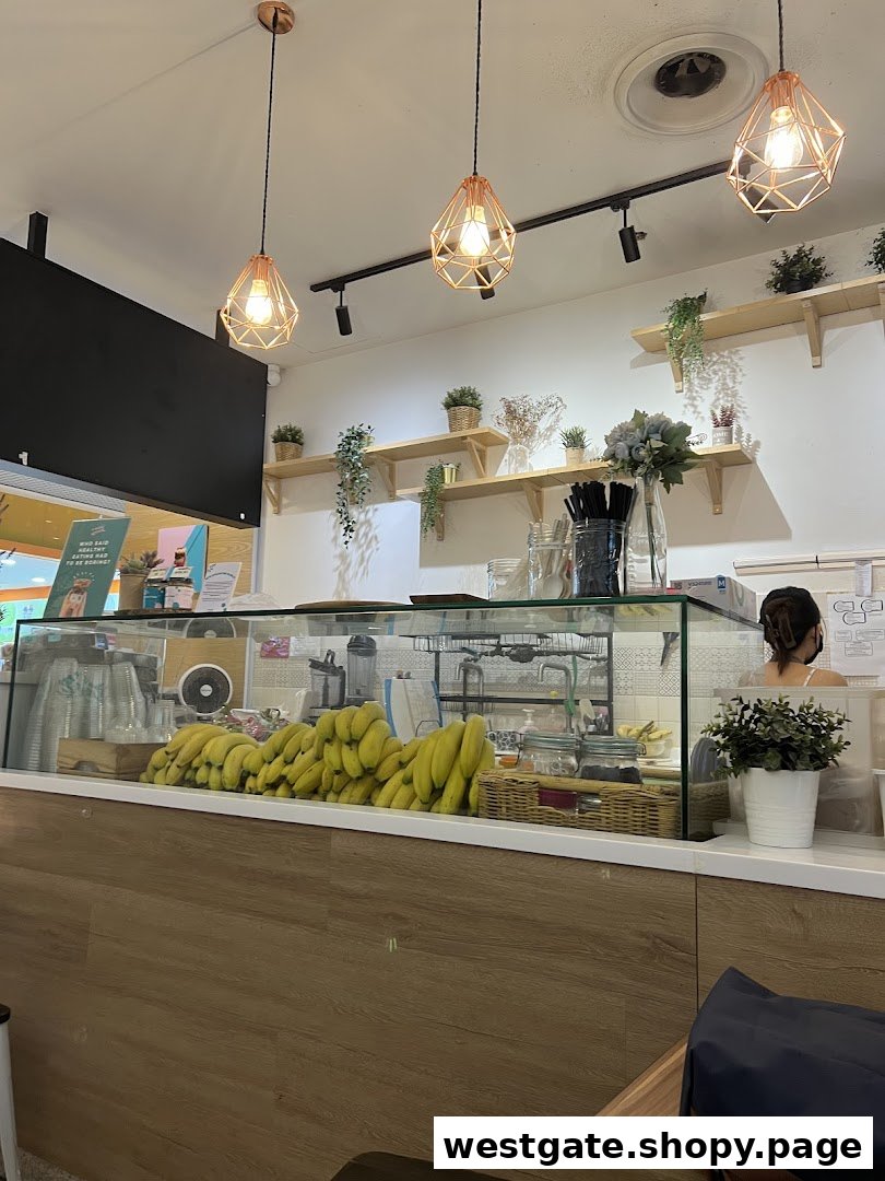Interior view of An Açaí Affair, showing the counter with fresh bananas and a staff member.