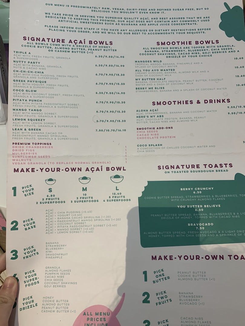 A detailed menu displaying a variety of açaí bowls, smoothies, toasts, and customizable options.