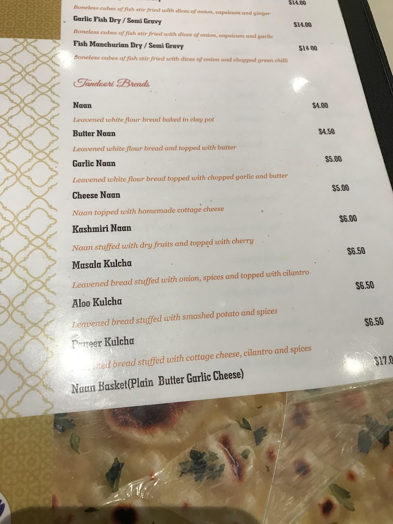 A close-up view of Anjappar's menu, featuring various Tandoori Breads and fish dishes with prices.