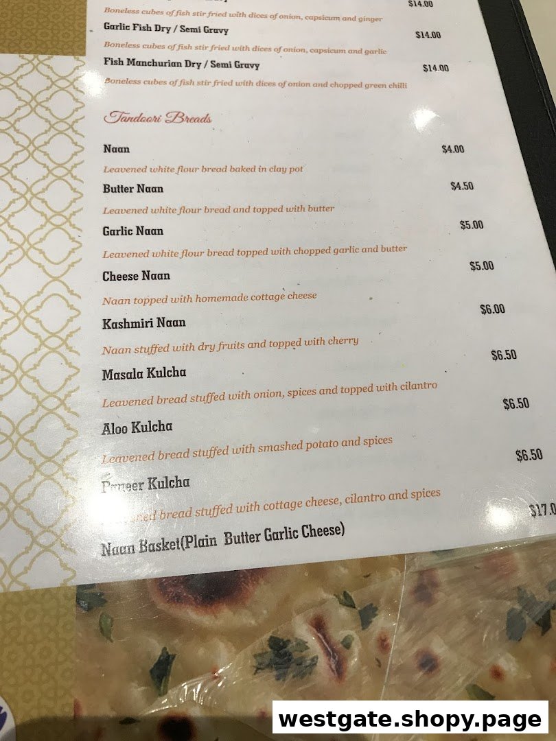 A close-up view of Anjappar's menu, featuring various Tandoori Breads and fish dishes with prices.