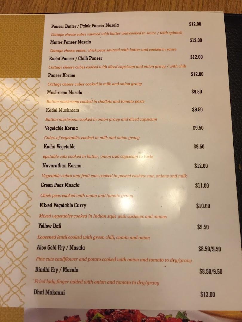 A detailed menu page showcasing a variety of vegetarian Indian main courses with prices and descriptions.