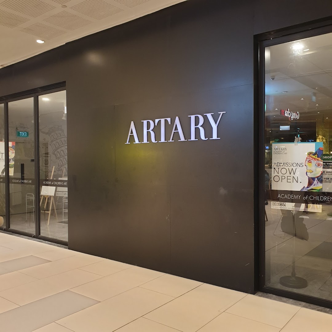 The shopfront of ARTARY, an academy of children's art, featuring its illuminated sign and entrance.