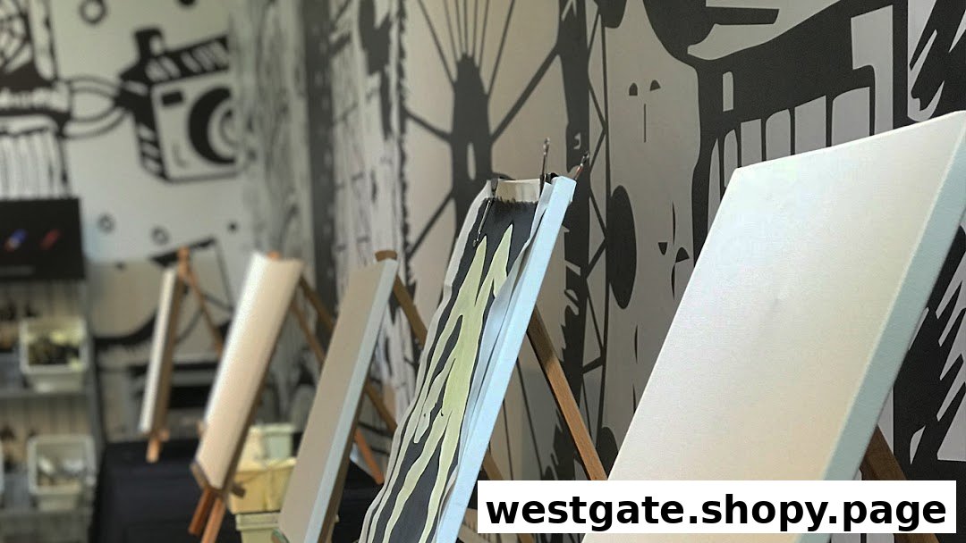 Easels with canvases set up for painting in an art studio with creative wall murals.