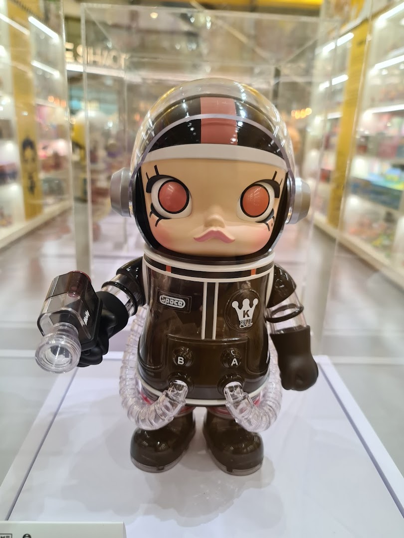 A detailed close-up of a Molly astronaut collectible figurine on display in a retail store.