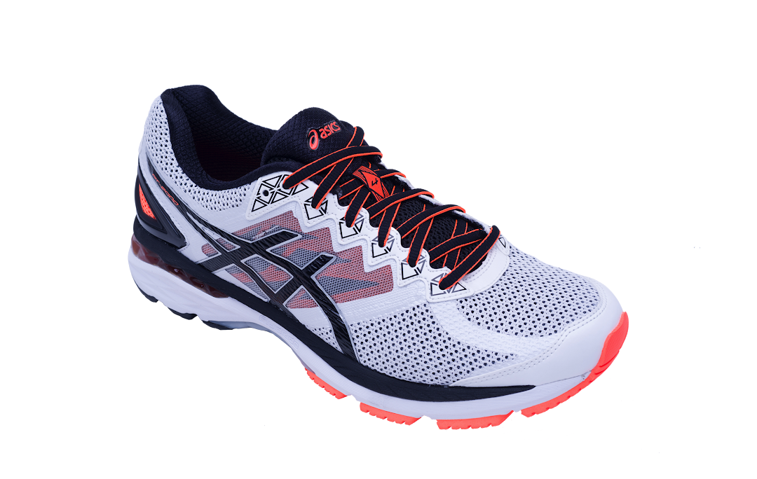 A white and black ASICS running shoe with vibrant orange accents, isolated on a black background.
