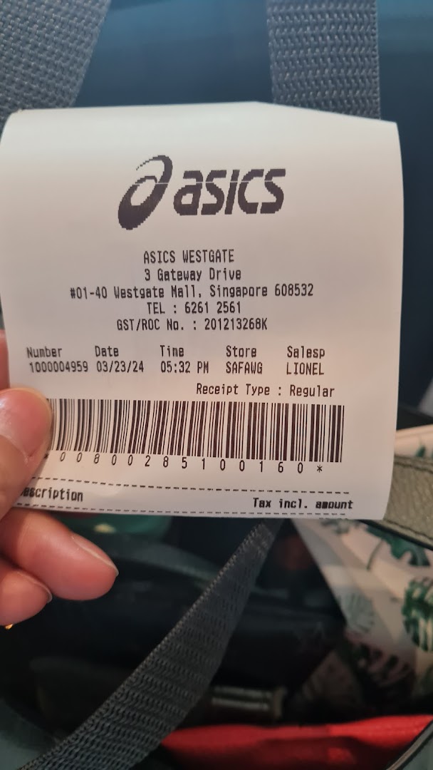 A close-up view of a retail receipt from the ASICS Westgate store, showing transaction details.