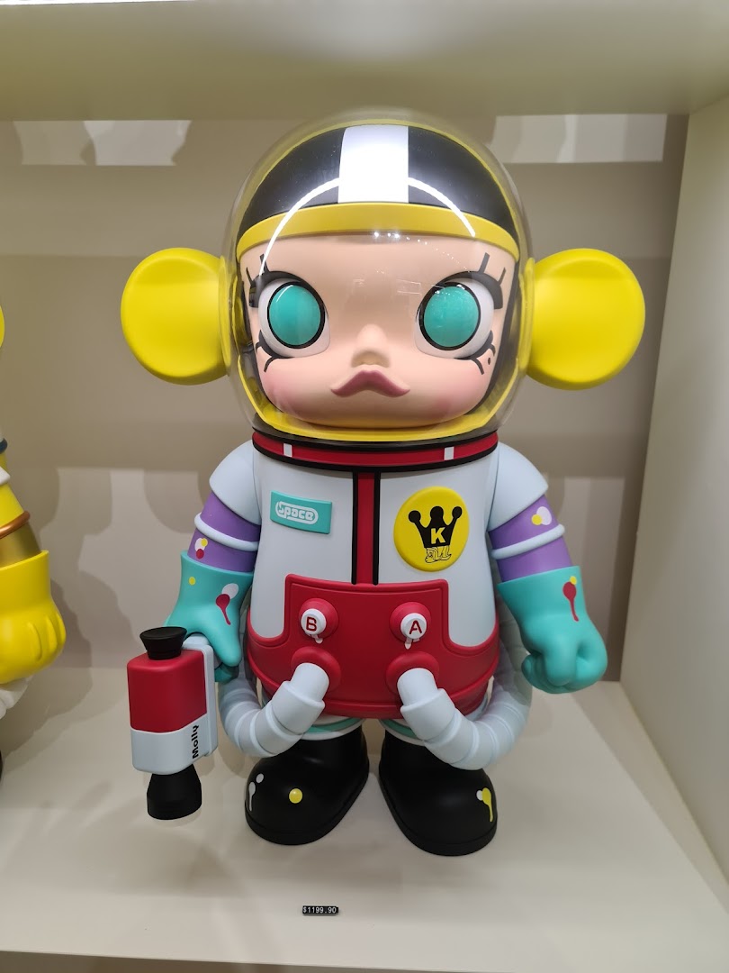 A detailed collectible figure of a character in an astronaut suit, displayed in a retail setting.