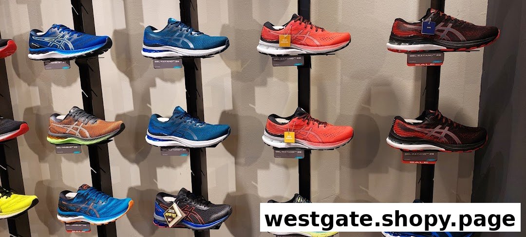 A vibrant display of ASICS running shoes in various models and colors on a retail wall.