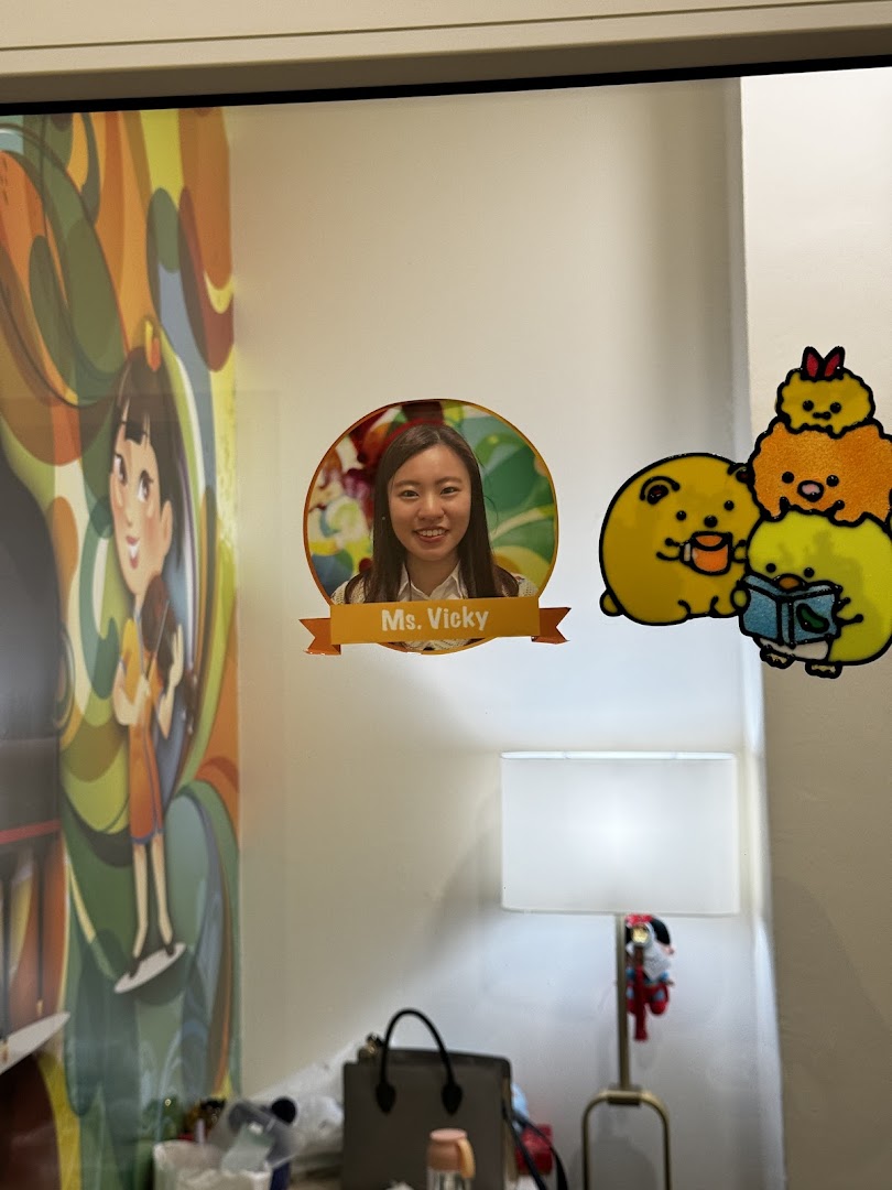 An interior shot of Aureus Academy featuring a staff photo of Ms. Vicky and cute cartoon decals.