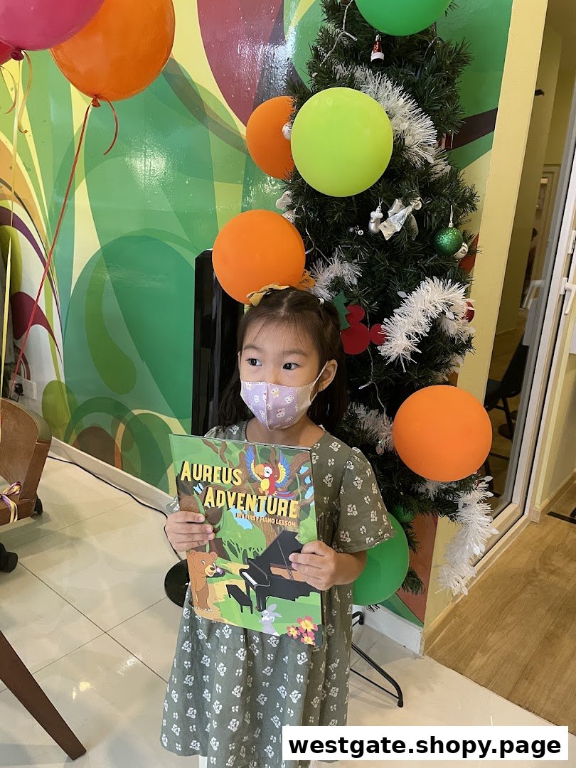 A young girl in a mask holds an 'Aureus Adventure' book next to a decorated Christmas tree and balloons.