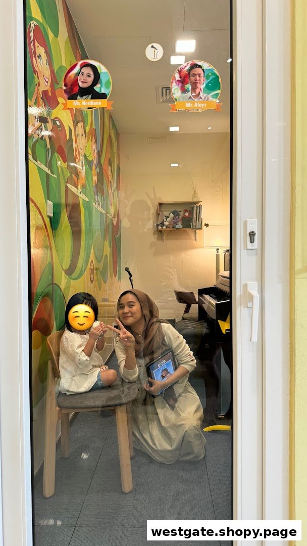 A teacher and student inside Aureus Academy, with colorful wall art and a piano visible.