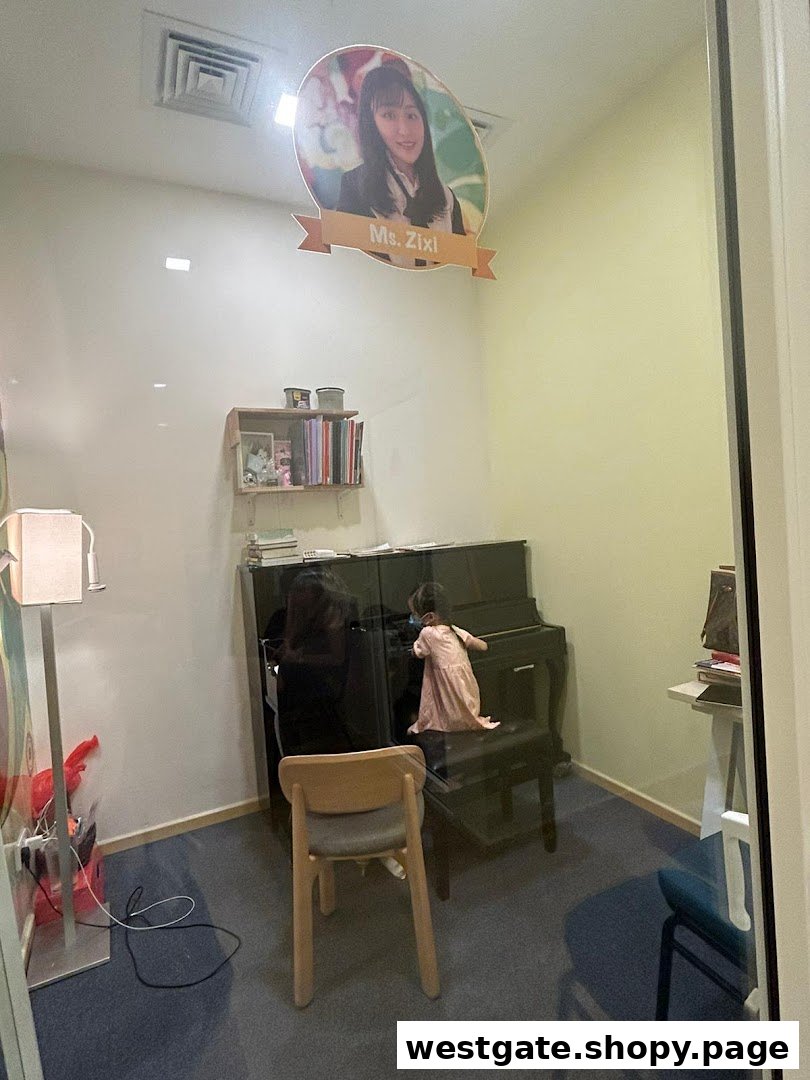 An interior view of a music lesson room at Aureus Academy, featuring a piano and a student.