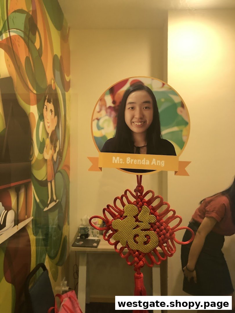Interior shot of Aureus Academy featuring a colorful mural, Ms. Brenda Ang's photo, and a Chinese knot.