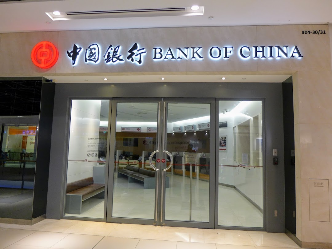 The illuminated exterior of Bank of China Jurong East Sub-Branch with its glass entrance.
