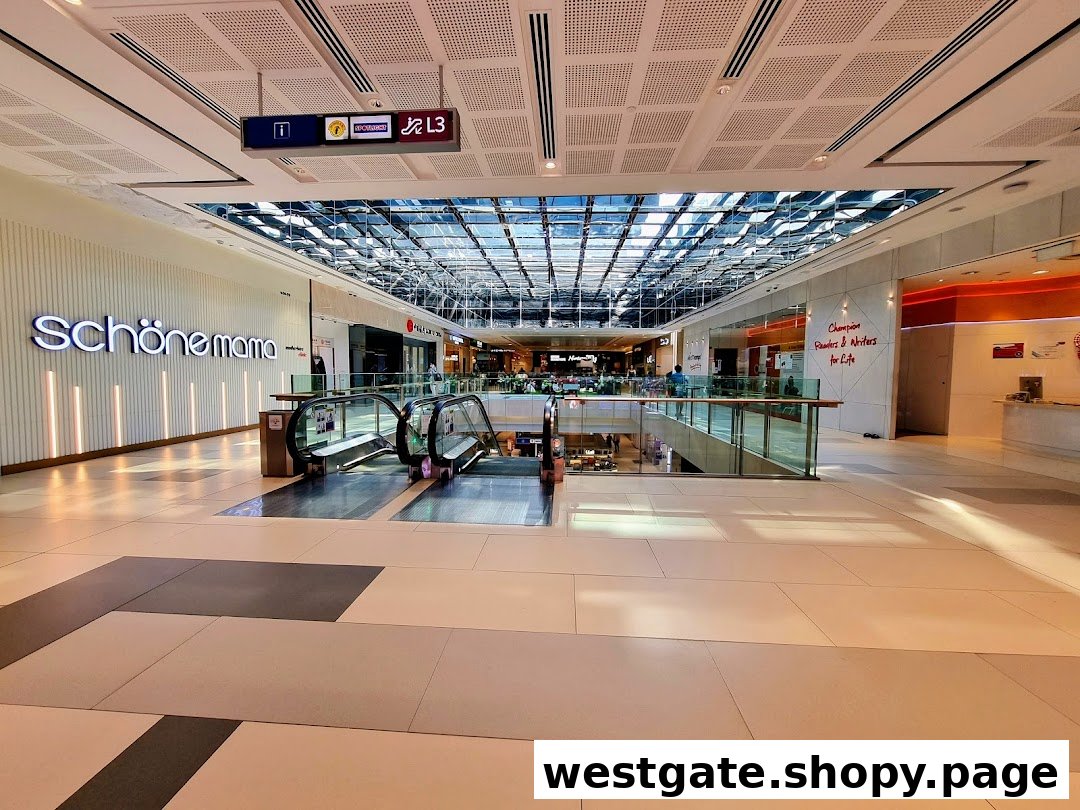 A bright, modern shopping mall interior featuring escalators and various shop fronts under a skylight.