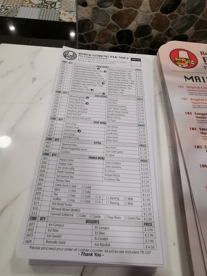 A detailed menu from Bebek Goreng Pak Ndut, showcasing a variety of Indonesian dishes and drinks.
