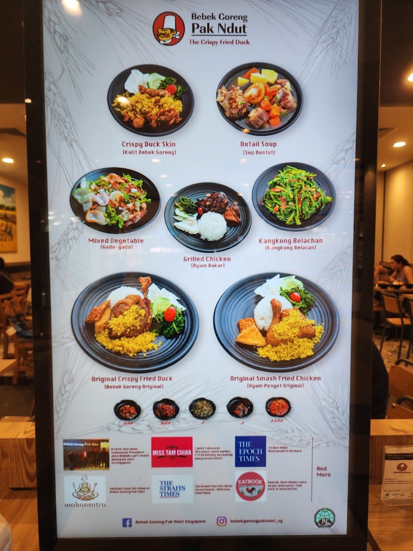 A digital menu board showcasing various Indonesian dishes with appealing food photography.
