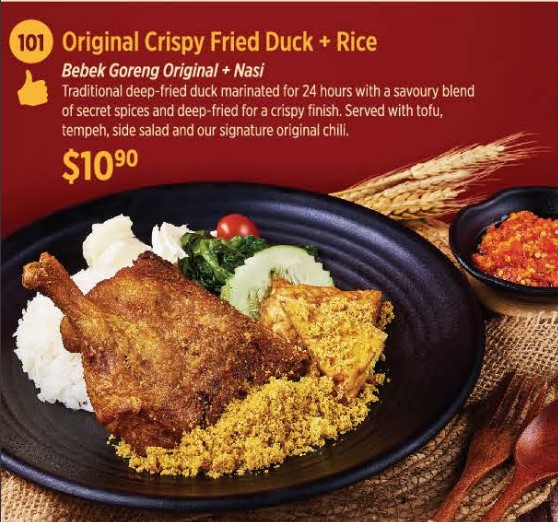 A plate of crispy fried duck with rice, tofu, tempeh, and chili sauce.