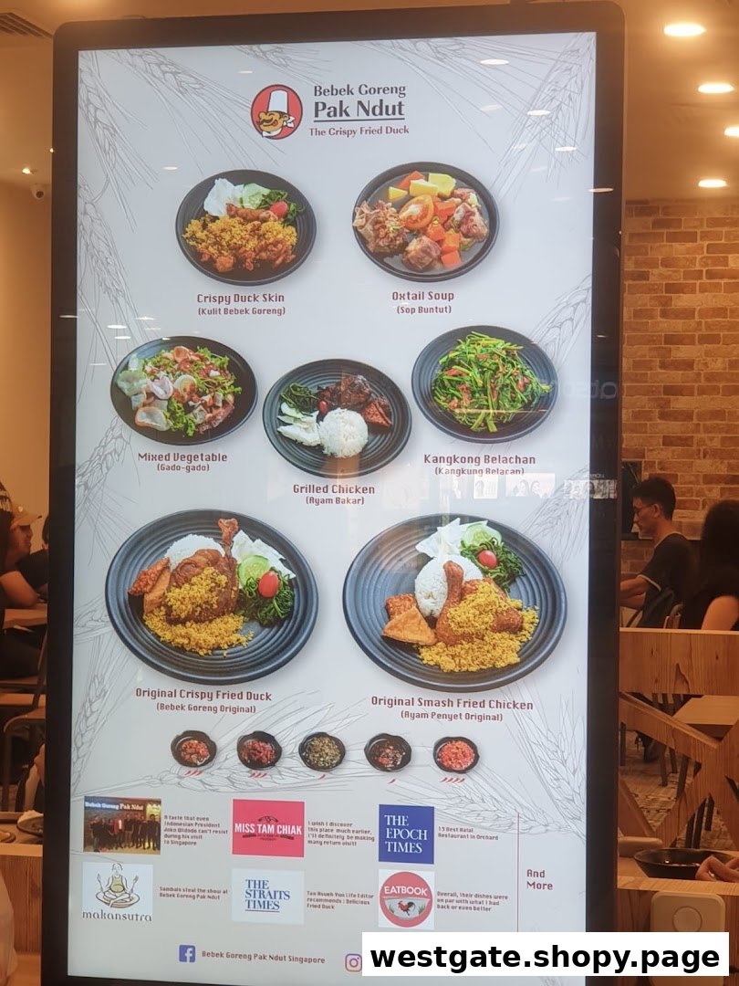 A digital menu board displaying various Indonesian dishes from Bebek Goreng Pak Ndut.
