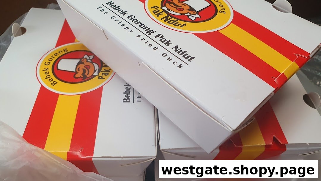 Close-up of multiple takeaway boxes featuring the logo of Bebek Goreng Pak Ndut.