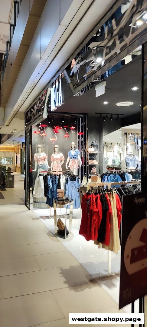 The shop front of BEGA, featuring mannequins displaying women's fashion and clothing racks with various apparel.
