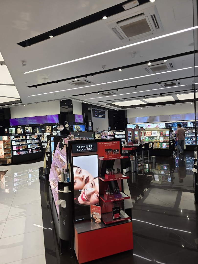 An interior view of a modern Sephora beauty store with various makeup and skincare displays.