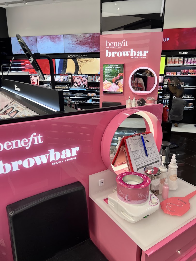A vibrant pink Benefit Browbar Beauty Lounge station inside Sephora, ready for beauty services.